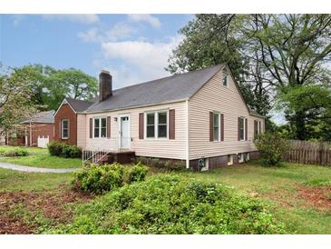 Charming home featuring light siding, dark shutters, and a well-maintained front yard at , Tucker, GA 30084