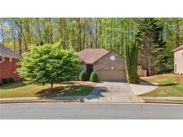 Charming single-Gathering home featuring a well-manicured front yard and inviting curb appeal in a lush, wooded neighborhood at 660 Gran Heritage Way, Dacula, GA 30019