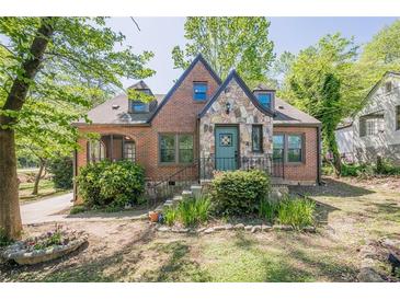 Charming brick home with stone accents, well-maintained lawn, and inviting curb appeal at 1884 Montrose Dr, East Point, GA 30344