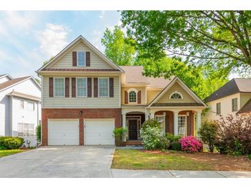 Charming two-story home boasts mature trees, well-manicured lawn and two-car garage at 2810 Stillwater Park Dr, Marietta, GA 30066
