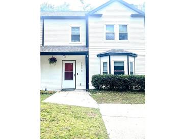 Charming home featuring clean white siding, black trim, and well-kept front yard at 2896 Lakemont Sw Dr, Marietta, GA 30060