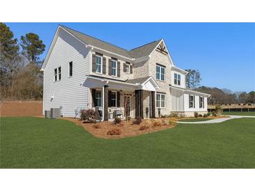 Charming two-story home with a mix of brick and siding, a well-manicured lawn, and inviting front porch at 2718 Byess Ct, Marietta, GA 30064