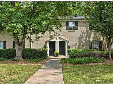 Charming two-story townhome with lush landscaping, brick facade and inviting walkway at 3665 Essex Ave # 28, Atlanta, GA 30339
