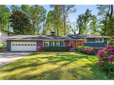Charming single-story home featuring a lush front lawn, gray siding, and brick accents at 3325 N Embry Cir, Atlanta, GA 30341
