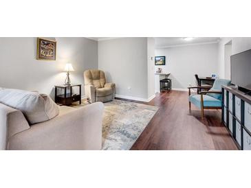 Inviting living room with neutral tones, plush seating, and an open floor plan to the dining area at 3085 Colonial Way # L, Atlanta, GA 30341