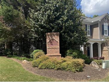 Dominion Station community sign surrounded by lush landscaping and mature trees at 4036 Carlinswood Way, Stone Mountain, GA 30083