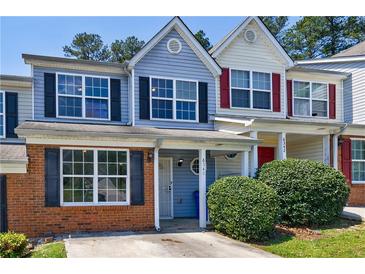 Charming townhome featuring brick accents, a covered porch, and well-maintained landscaping at 6340 Hickory Lane Cir, Union City, GA 30291