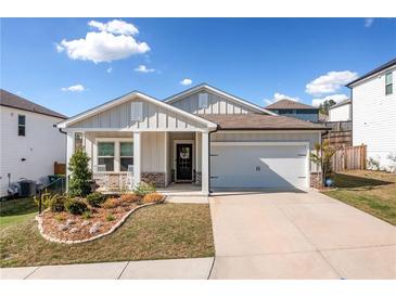 Charming single-story home with a well-manicured lawn, inviting front porch, and a convenient two-car garage at 530 Payne Rd, Woodstock, GA 30188