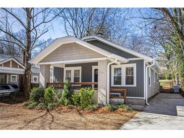 Charming bungalow featuring a covered front porch, gray siding, and landscaped yard at 1045 Moreland Se Ave, Atlanta, GA 30316