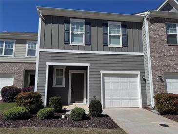 Charming two-story home featuring gray siding, a single-car garage, and a well-manicured front lawn at 3333 Tarian Way, Decatur, GA 30034