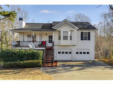Charming two-story home featuring a spacious front porch, two-car garage, and landscaped yard at 674 Fairview Dr, Dallas, GA 30157