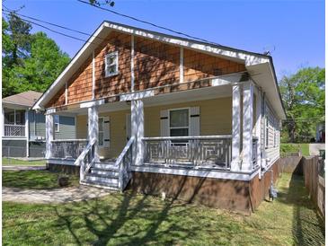 Charming home with a inviting front porch, decorative railings, and attractive cedar shingle detail at 2264 Pryor Rd, Atlanta, GA 30315