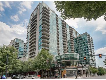 Modern high-rise condo building with balconies, and a restaurant on street level at 943 Peachtree Ne St # 1910, Atlanta, GA 30309