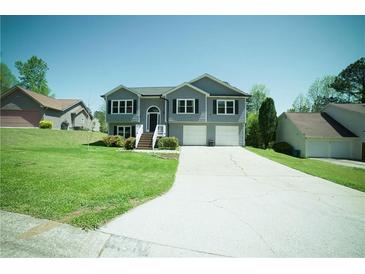 Charming two-story home with a well-manicured lawn and a two-car garage at 660 Allens Landing Dr, Lawrenceville, GA 30045
