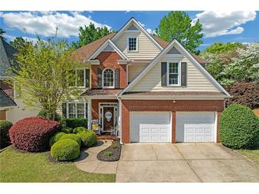Beautiful two-story home featuring a brick and siding exterior, well-manicured lawn, and two-car garage at 1549 Tappahannock Trl, Marietta, GA 30062