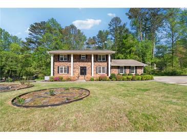 Beautiful brick home with a large front yard and mature trees at 244 Saint Patrick Sw Dr, Mableton, GA 30126