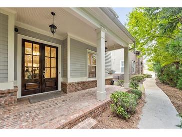 Charming front porch features brick flooring, hanging lights, and inviting double doors at 201 Saddle Rd, Alpharetta, GA 30009