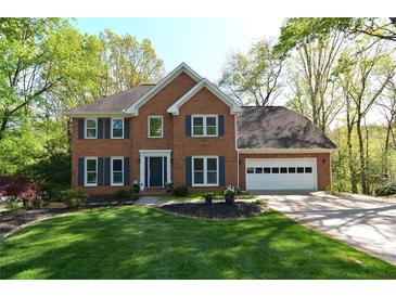 Charming two-story brick home with a well-manicured lawn and attached two car garage at 2815 Cambridge Hills Rd, Cumming, GA 30041