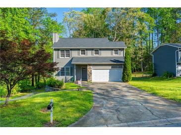 Charming two-story home with gray siding, stone accents, and a well-manicured lawn at 3988 Centennial Trl, Duluth, GA 30096