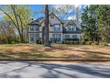 Charming two-story home with a well-manicured front yard and mature trees at 3139 Players Dr, Jonesboro, GA 30236