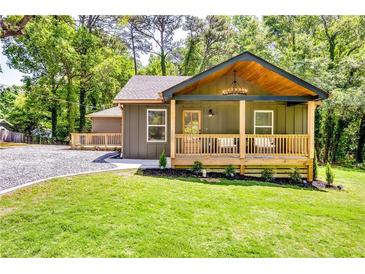 Charming home with a covered front porch, stylish lighting, and lush green lawn at 3244 Mount Olive Rd, Atlanta, GA 30344
