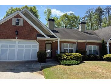 Charming brick home with a well-maintained lawn, attached garage, and a cozy front entrance at 2575 Rosehill Circle, Lithia Springs, GA 30122