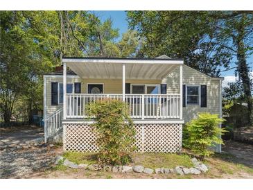 Charming single-story home with a covered front porch and well-maintained landscaping at 6149 Josephine Rd, Atlanta, GA 30340