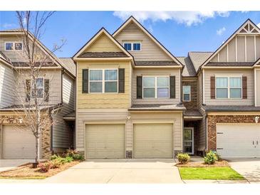 Charming townhome featuring a two-car garage and neutral-toned exterior at 1546 Silvaner Nw Ave # 20, Kennesaw, GA 30152