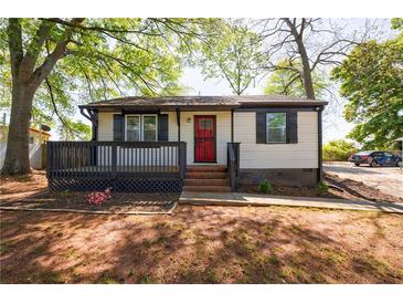 Charming single-story home features a red door, black shutters, and a cozy front porch at 2077 Perkerson Rd, Atlanta, GA 30310