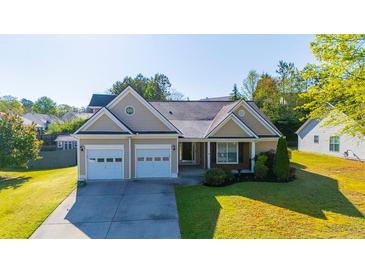 Charming single-Gathering home featuring a two-car garage and a well-manicured front lawn at 1910 Charleston Oak Cir, Lawrenceville, GA 30043