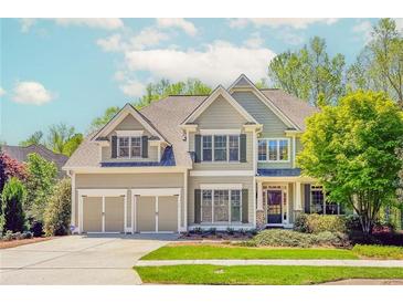 Charming two-story home with a well-manicured lawn, attached two car garage, and mature trees at 4106 Creekview Ridge Ne Dr, Buford, GA 30518