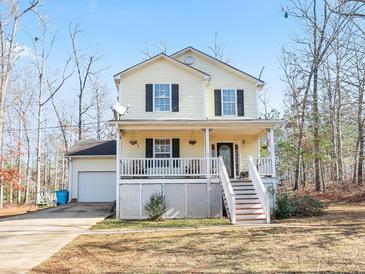 Charming two-story home featuring a welcoming front porch and well-maintained yard at 45 Hunters Ridge Ct, Covington, GA 30014