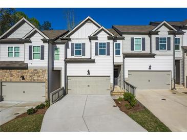 Charming townhome with neutral paint, driveway, and attached garages in a desirable neighborhood at 518 Scenic Pass, Woodstock, GA 30189