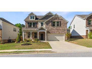 Charming brick two-story home with a well-manicured lawn and a two-car garage at 1840 Wellston Dr, Lawrenceville, GA 30043