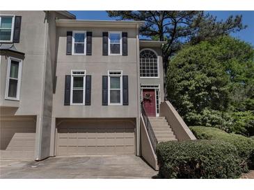 Stylish two-story townhouse featuring a two-car garage and a charming entrance with steps at 2518 Oakwood Se Way, Smyrna, GA 30080