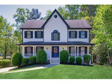 Charming two-story home with a welcoming front porch and well-manicured lawn at 1420 Midland Way, Lawrenceville, GA 30043