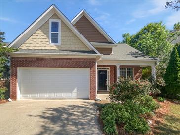 Charming two-story home with brick accents, a well-manicured lawn, and an attached two-car garage at 5763 Mitchell Chase Trl, Mableton, GA 30126