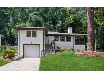 Charming exterior elevation featuring a garage and landscaped front yard perfect for a Gathering at 1753 Detroit Nw Ave, Atlanta, GA 30314