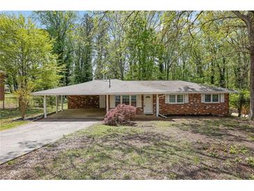 Charming single-story brick home with a carport and well-maintained landscaping at 1093 Lanier Sw Dr, Marietta, GA 30060