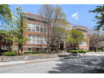 Beautiful brick apartment building with large windows, lush greenery, and well-maintained surroundings at 978 North Ne Ave # 207, Atlanta, GA 30306