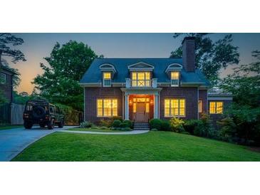 Charming brick home with manicured lawn, lush landscaping, and inviting entrance, perfect for suburban living at 1116 Dan Johnson Ne Rd, Atlanta, GA 30307