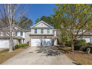 Charming two-story home featuring a two-car garage and traditional design with a well-maintained front yard at 373 Hidden Creek Ln, Canton, GA 30114