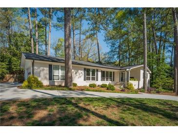 Charming brick home with manicured lawn and mature trees creating a welcoming curb appeal at 2590 Hawthorne Ne Pl, Atlanta, GA 30345
