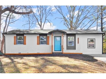 Charming single-story home with a freshly painted exterior and a bright blue front door at 3460 Fairlane Dr, Atlanta, GA 30331