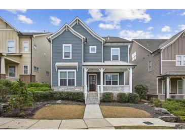 Charming two-story home featuring a cozy front porch and well-manicured landscaping at 26 Hardpan Aly, Marietta, GA 30066