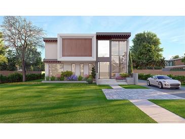 Modern two-story home featuring a well-manicured lawn, manicured landscaping, and an attached two-car garage at 1484 N Druid Hills Ne Rd, Brookhaven, GA 30319
