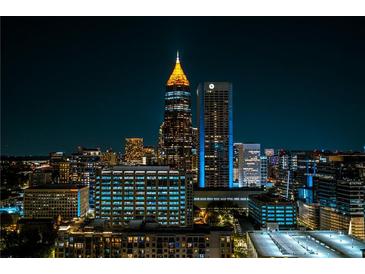 Nighttime cityscape view featuring illuminated skyscrapers against a dark sky, showcasing urban living at 860 Peachtree Ne St # 2716, Atlanta, GA 30308