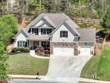 Beautiful home featuring a manicured lawn and three-car garage, nestled in a wooded neighborhood at 453 Thorn Creek Way, Dallas, GA 30157