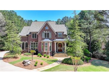 Beautiful brick home with a manicured lawn and lush landscaping, creating a welcoming curb appeal at 4505 Whitestone Way, Suwanee, GA 30024