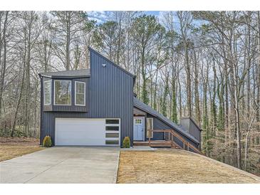 Striking modern exterior with a unique architectural design and a two-car garage with an extra upper bay window at 3214 Cedar Bluff Ne Dr, Marietta, GA 30062